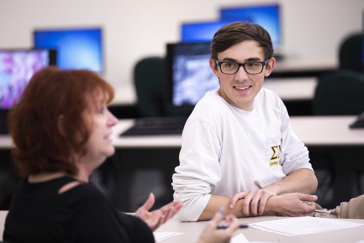 management major internship student smiles in class