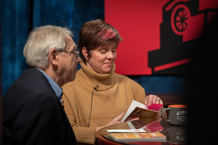 A student in SE Creative receives a plaque for a gold ADDY Award.