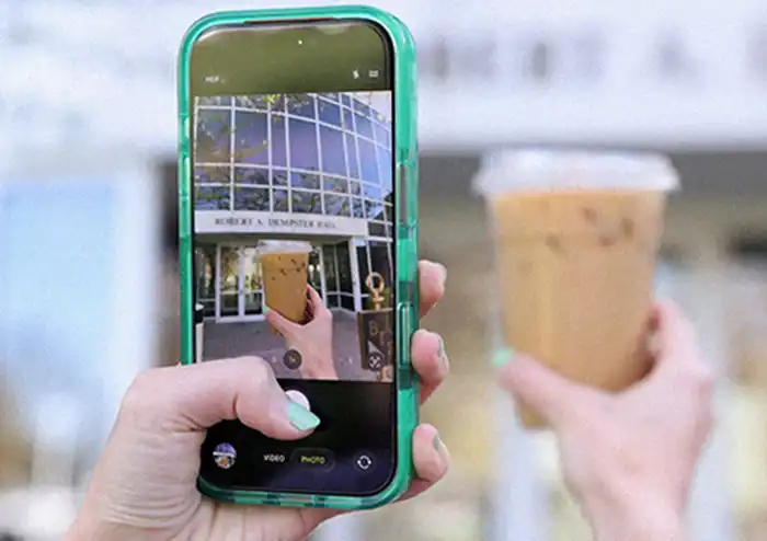 closeup of student taking pictures outside at her local marketing internship showcasing what you can do with a marketing degree. 