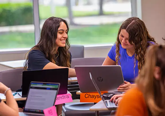 two marketing students have a conversation in class as a part of project-based learning.