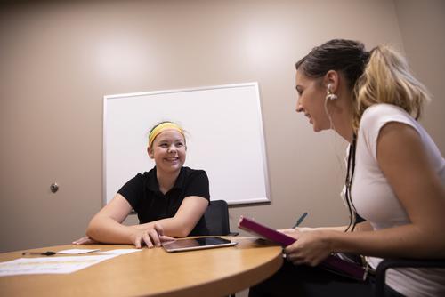 A communication disorders student works with a child at The Center for Speech and Hearing.