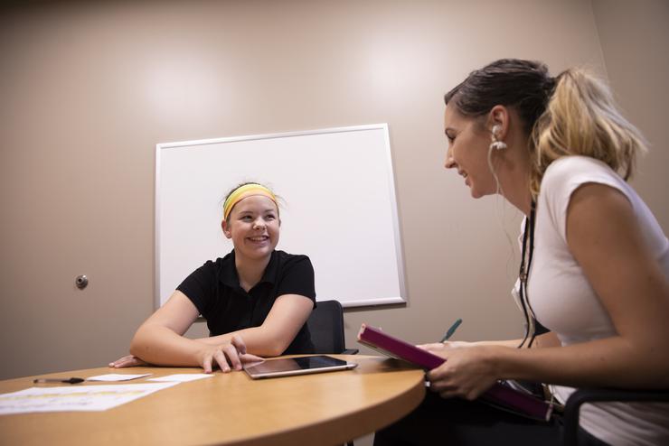 A communication disorders student works with a child at The Center for Speech and Hearing. 