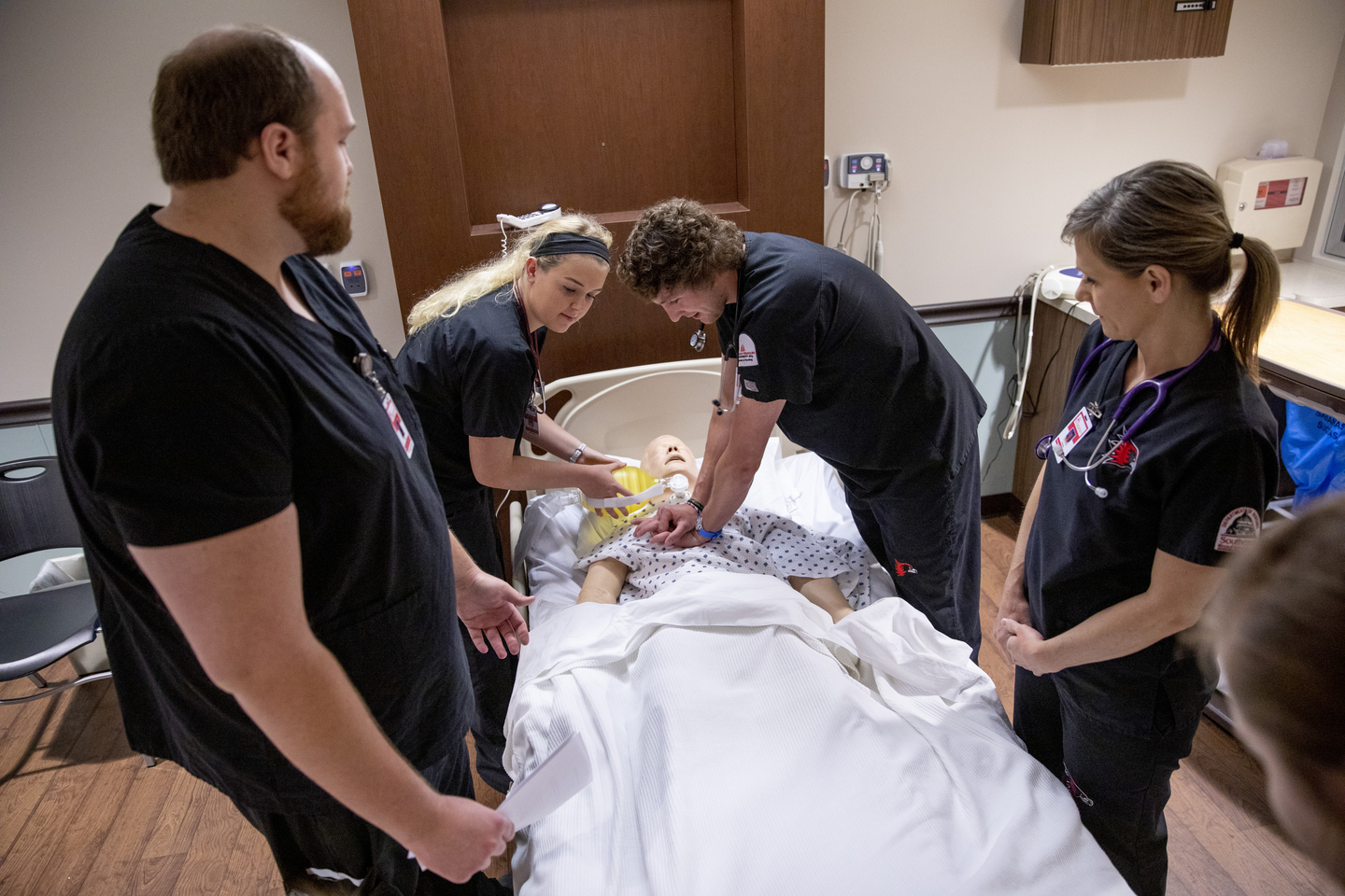 Nursing students work inside a simulation lab at a local hospital. 