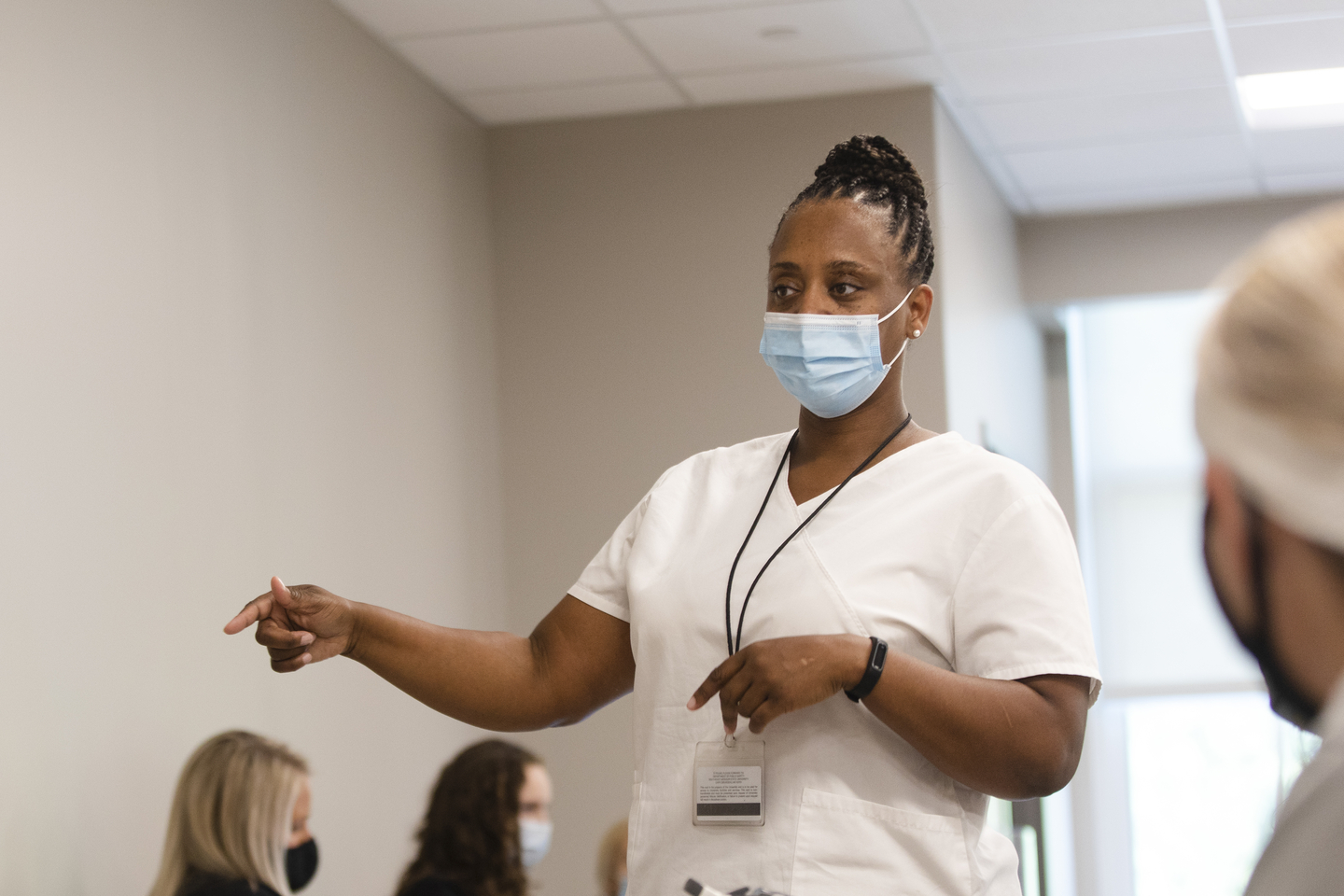 A nursing professor gives a lecture in a class.