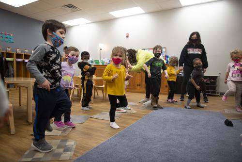 Students at the USYC stand while participating in an activity
