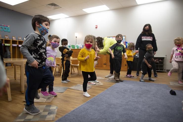Students at the USYC stand while participating in an activity