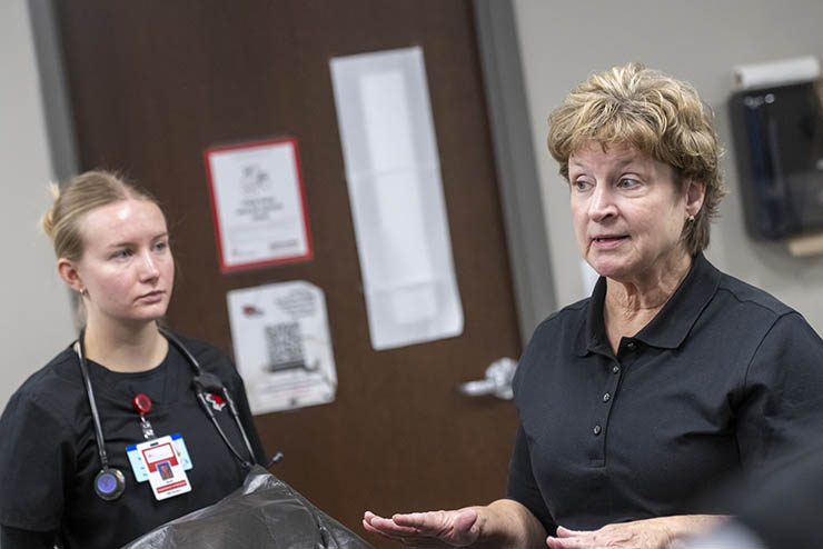 A nursing professor gives a lecture in a class.