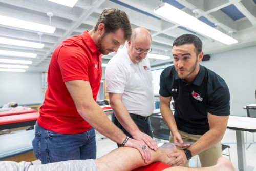 An athletic training student learns how use tools to measure on the body.