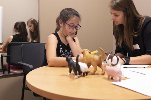 A Communication Disorders major student works one on one with a patient at the Center for Speech and Hearing.