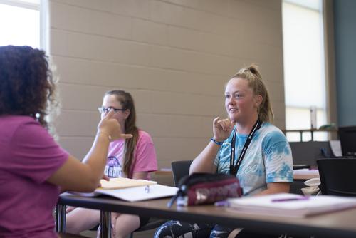 Communication Disorders major students practice using sign language