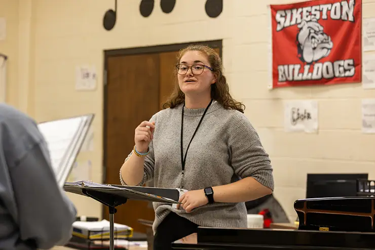 A music secondary education student teaching in a high school classroom