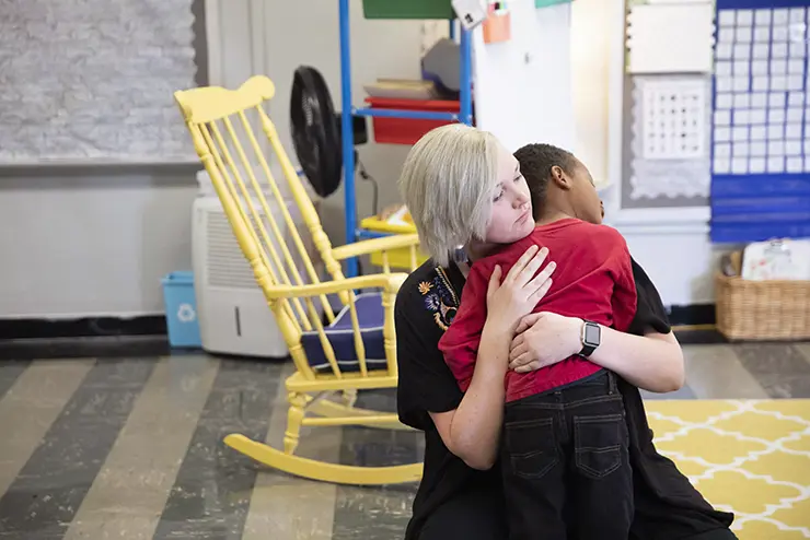 a semo student teacher candidate hugs a child