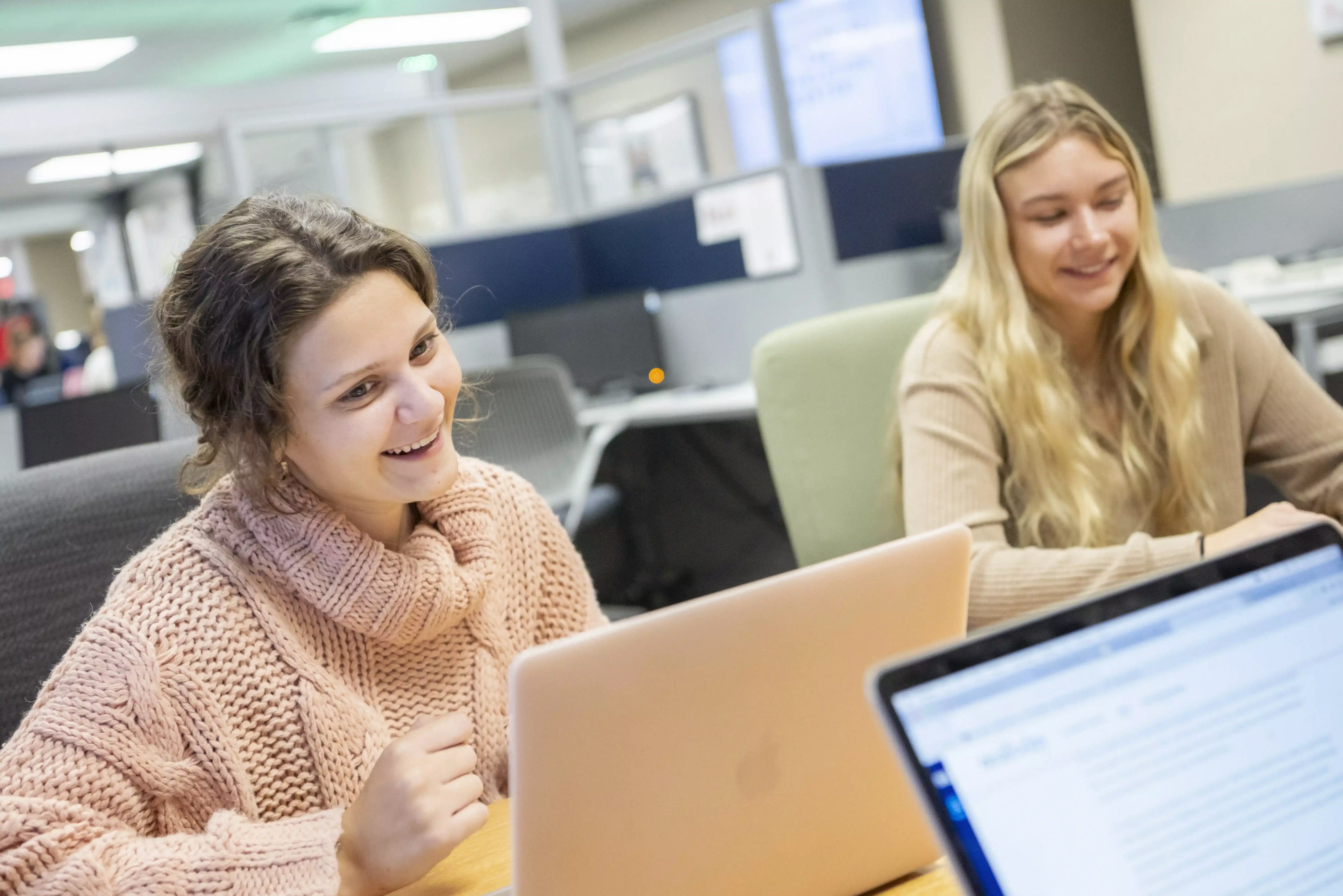 two education students working in the ed volution center for a career preperation project
