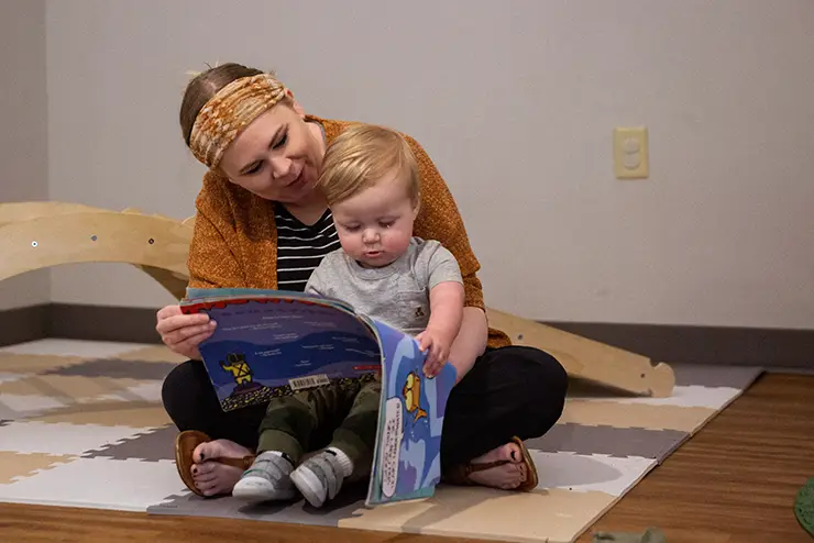 a SEMO student teacher reads a book to a toddler