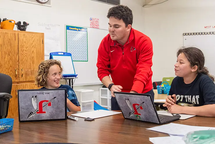 a SEMO student teacher works in a classroom with actual high school students