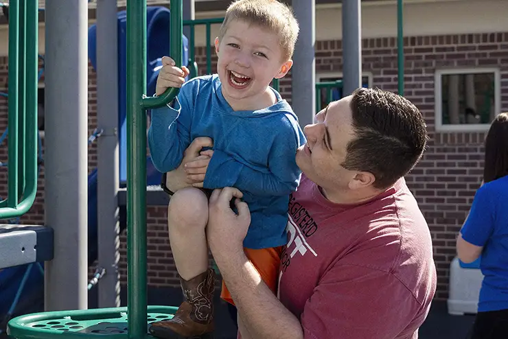 a SEMO exceptional child major student teacher plays with a boy at the autism center