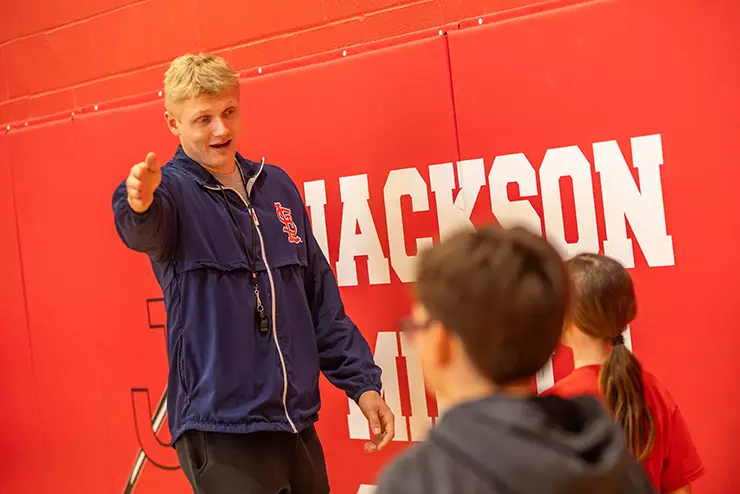 a SEMO student teacher candidate instructs a child during gym class at Jackson Schools