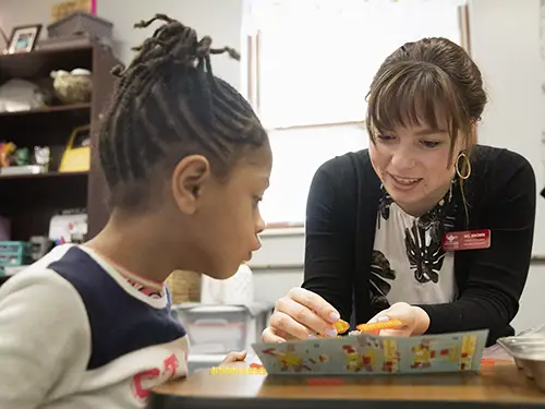 a SEMO student teacher works on a lesson with a young pupil