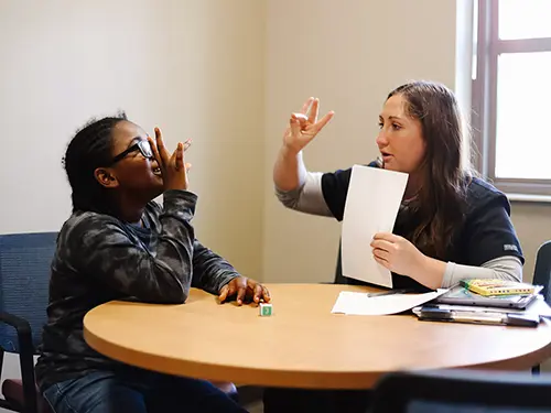 a communication disorders major works with a young student