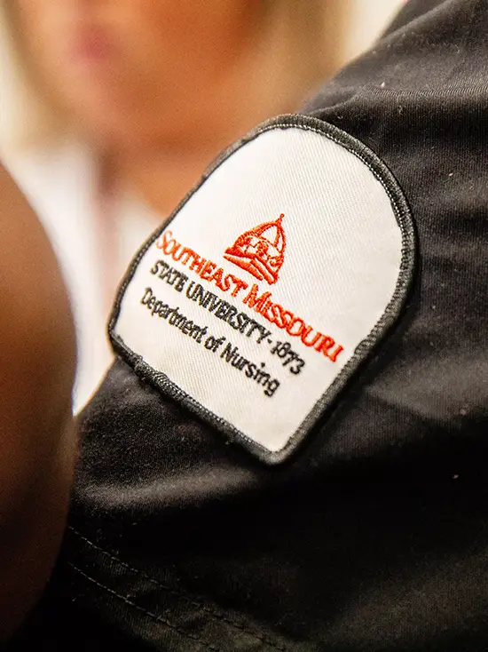 a southeast missouri state university department of nursing patch on the sleeve of someone's scrubs