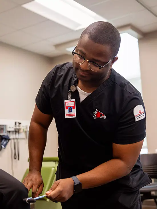 Brodrick, first year nursing student at SEMO checks a classmate's reflexes