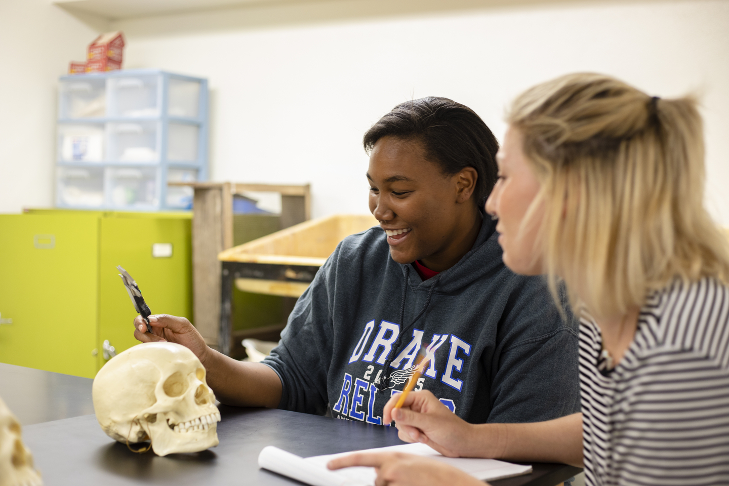 Anthropology students work together to examine human remains.