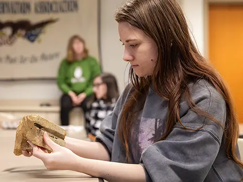 a history major student examines a piece of brick during a historical preservation class at semo a Missouri college known for job readiness