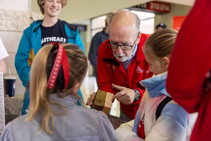 Dr Hoffman, a SEMO history professor shows an example to children at college night