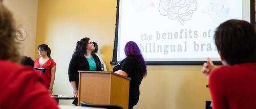 Southeast students present on a projector at the front of a classroom.