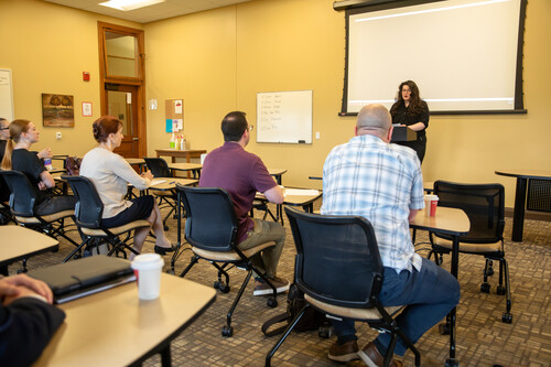 During a speech competition, a competitor stands in front of a panel.
