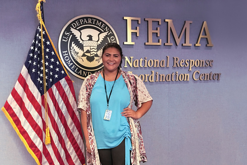 Southeast Communication Studies major, Myriah Bernard in front of a FEMA sign during her internship.