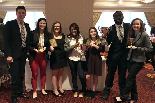 Southeast’s Debate team poses with awards including, national champions, following a competition.