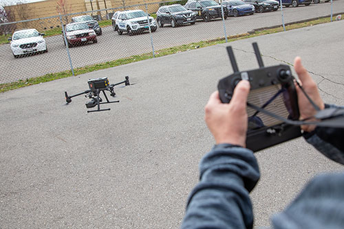 Students fly a drone.
