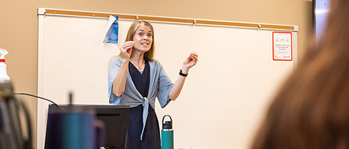 The social work teacher teaches class.