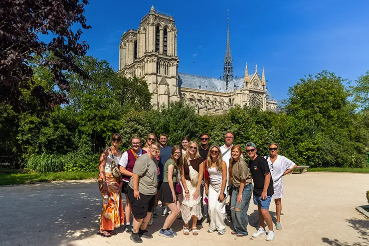 a group of students from SEMO poses for a photo with the Notre Dame Cathedral in the background while they are visiting France studying abroad