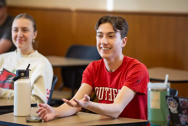 a communication student gestures while he participates in class at semo a Missouri college known for job readiness