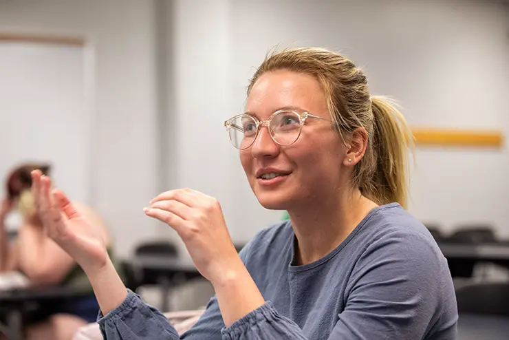 an english student gestures while she participates in a discussion in class at semo a Missouri college known for job readiness