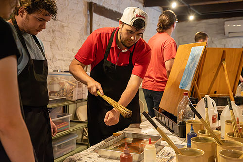 The historic preservation field trip where participants are painting.
