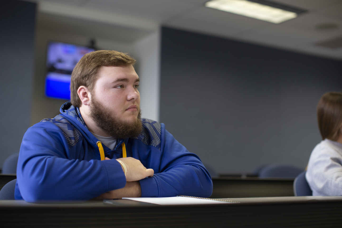 A student listens to a lecture in a political science class.