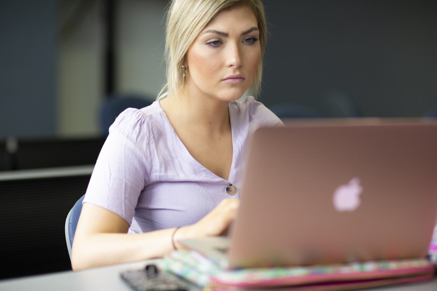 A student studies at a laptop during a political science class.