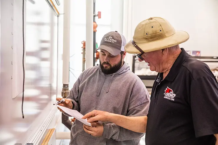 an agriculture student and his instructor go over classwork