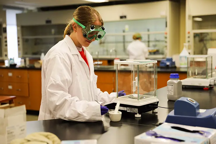 a group of Chemistry students work together in a lab on a project