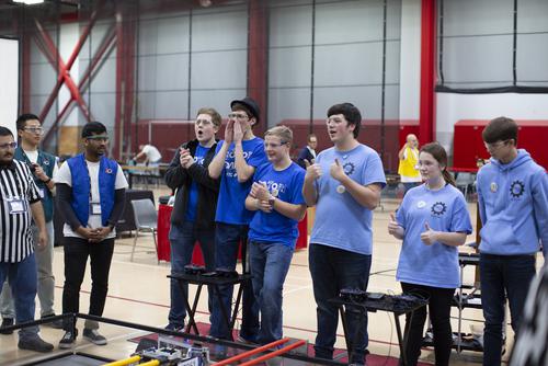 Students react to their robot’s performance during the Robotics Competition.