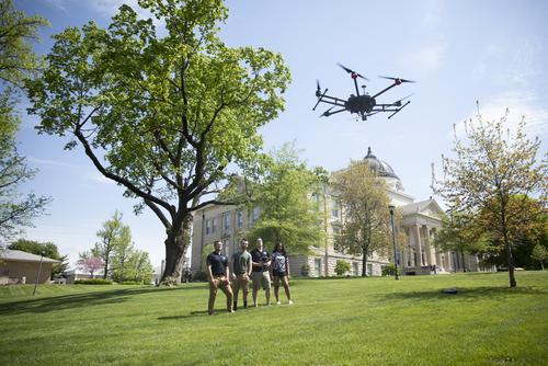 Students fly a drone near Academic Hall.
