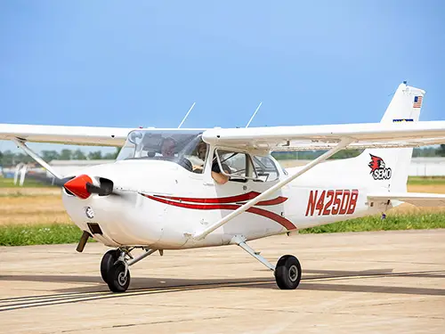 a SEMO branded cessna plane takes off down the runway with a student pilot at the controls