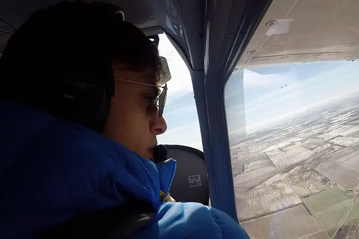 a SEMO professional pilot student sits in the pilot's seat and takes a practice flight