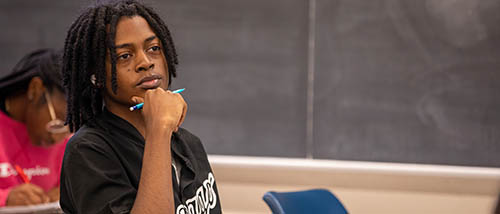 a southeast missouri state university math student listens intently to their professor during class