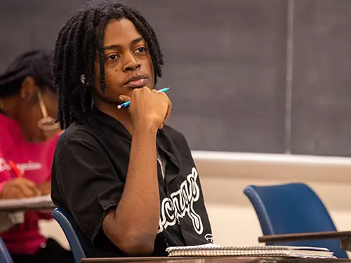 a southeast missouri state university math student listens intently to their professor during class