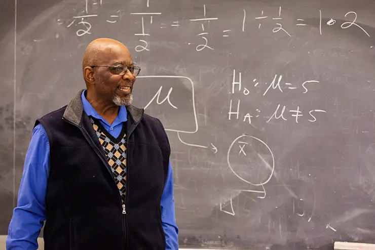 a math instructor at SEMO stands at the blackboard during class