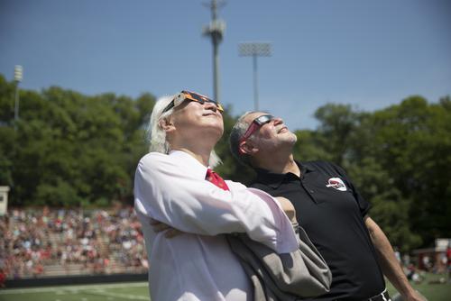 Physicist Dr. Michio Kaku and President Carlos Vargas wear eclipse glasses during the 2017 eclipse.